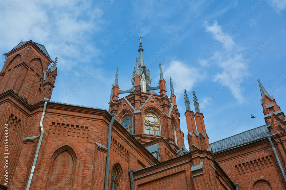 Upper part of the Catholic cathedral on the sky background