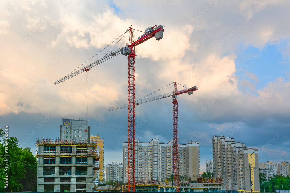 High construction cranes on a construction site