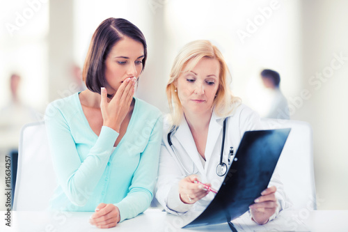 doctor with patient looking at x-ray