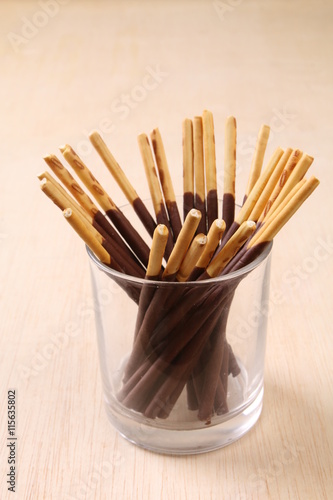 Chocolate dipped biscuits sticks in glass holder
