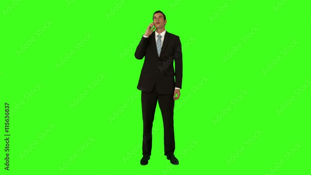 Businessman talking on the phone on green screen background Businessman talking on the phone on green screen background