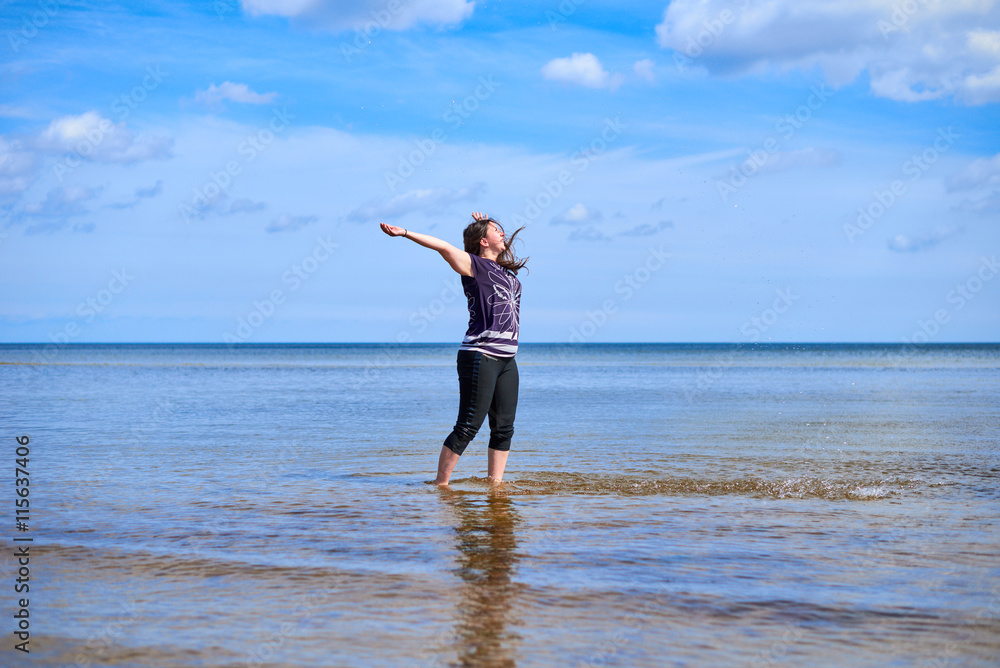Happy young woman sprays water Happy young woman sprays water