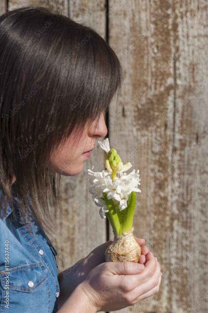Woman holding in hands a white hyacinth flower Woman holding in hands a white hyacinth flower