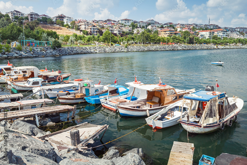Obraz premium Old wooden fishing boats moored in small port