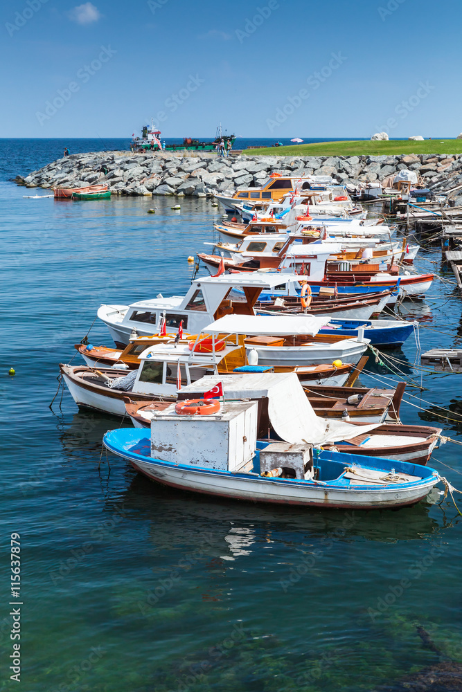 Vertical photo of colorful wooden fishing boats