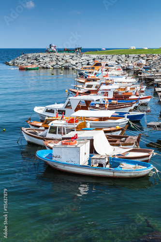 Vertical photo of colorful wooden fishing boats