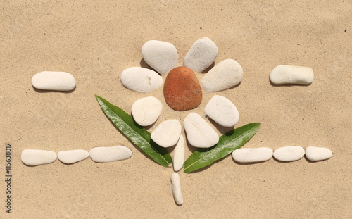 flower stone, lying on the sand. made of white pebbles and red. for designers and print