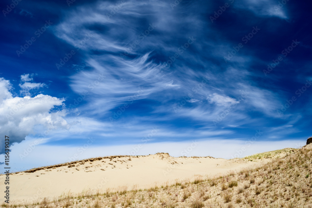 Spectacular cloudy sky over sandy ground
