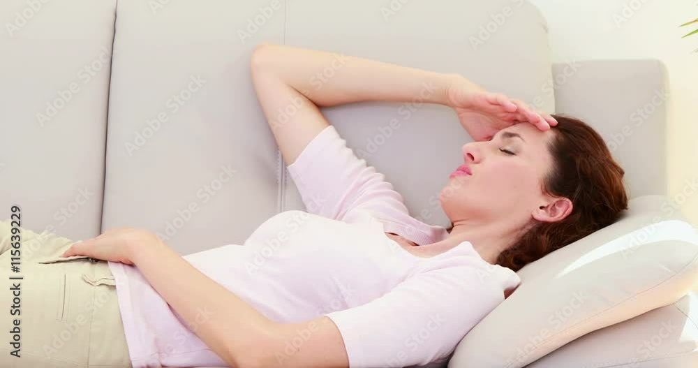Sad brunette lying on the couch Sad brunette lying on the couch
