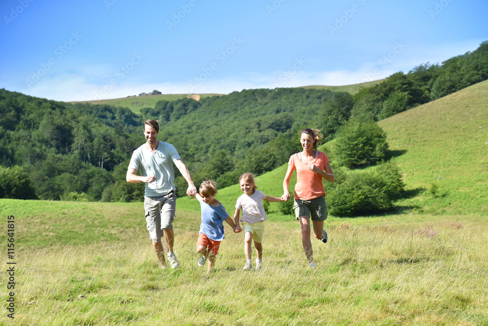 Family on vacation running down the hill Family on vacation running down the hill