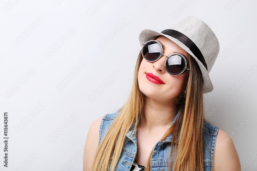 Portrait of a beautiful hipster girl on grey background Portrait of a beautiful hipster girl on grey background