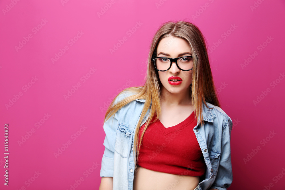 Portrait of a beautiful hipster girl on pink background Portrait of a beautiful hipster girl on pink background