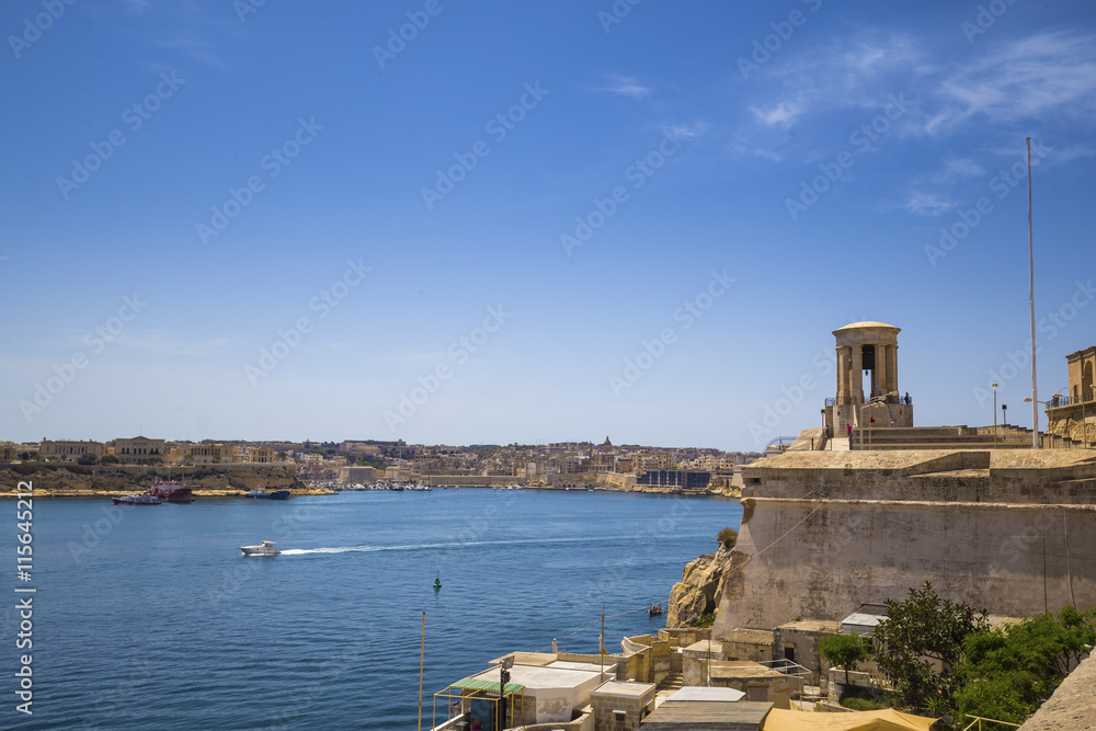 Malta - Siege Bell War Memorial and The Grand Harbour of Malta with clear blue sky