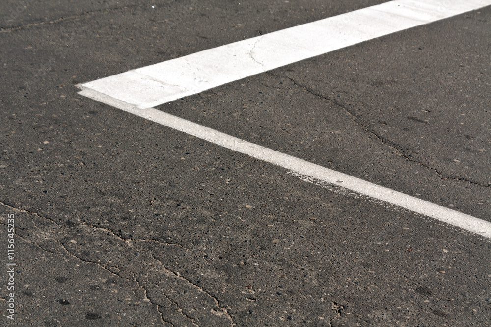 Fototapeta premium White paint mark on the old asphalt road.