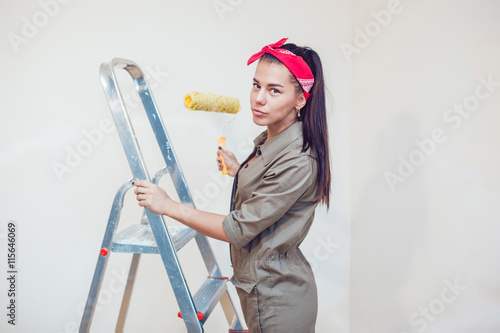 Beautiful young woman doing repairs.