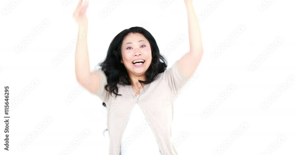 Elated Asian woman gesturing on white screen Elated Asian woman gesturing on white screen