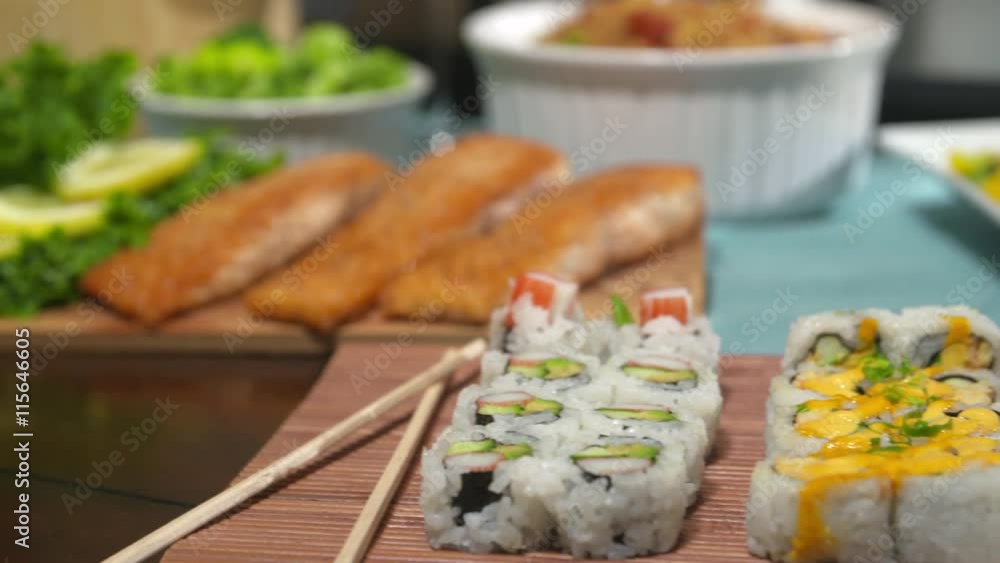 Salmon Move to Sushi on Table Close Up. camera moves right and racks focus from salmon on a cedar board to a variety of sushi with chop sticks
Salmon Move to Sushi on Table Close Up. camera moves right and racks focus from salmon on a cedar board to a variety of sushi with chop sticks