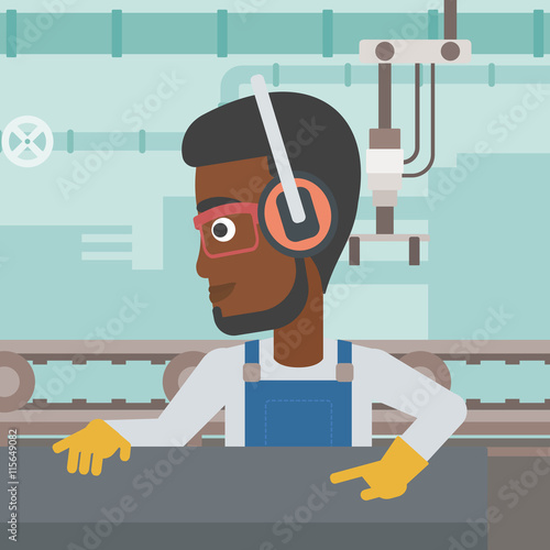 Man working on metal press machine.