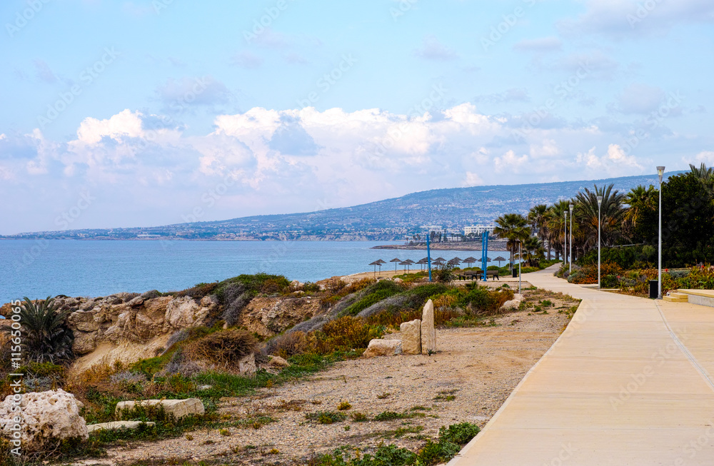 Walkway along sea coast with mountains view. Mediterranean Sea, Cyprus, Paphos region.