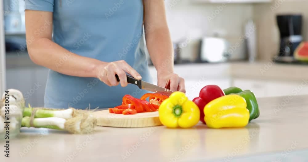 Woman preparing vegetables on the chopping board Woman preparing vegetables on the chopping board