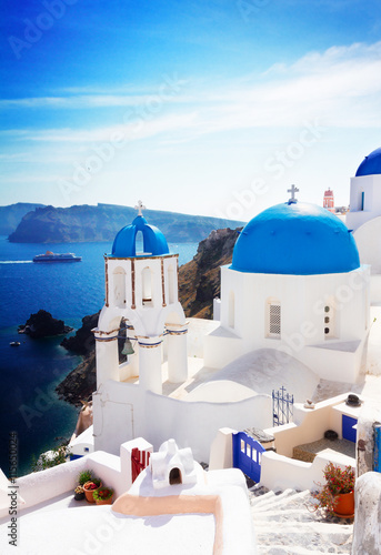 view of caldera with stairs and classical church with blue domes , Oia, Santorini, Greece , toned
