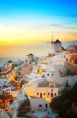 lights of Oia village at evening, Santorini island, Greece, toned