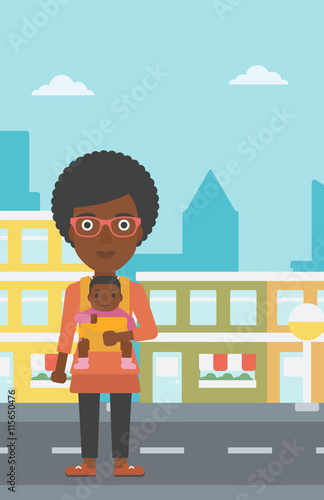 Mother carrying her son in sling.