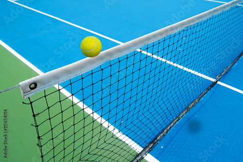 tennis ball crossing net in tennis court © lunx