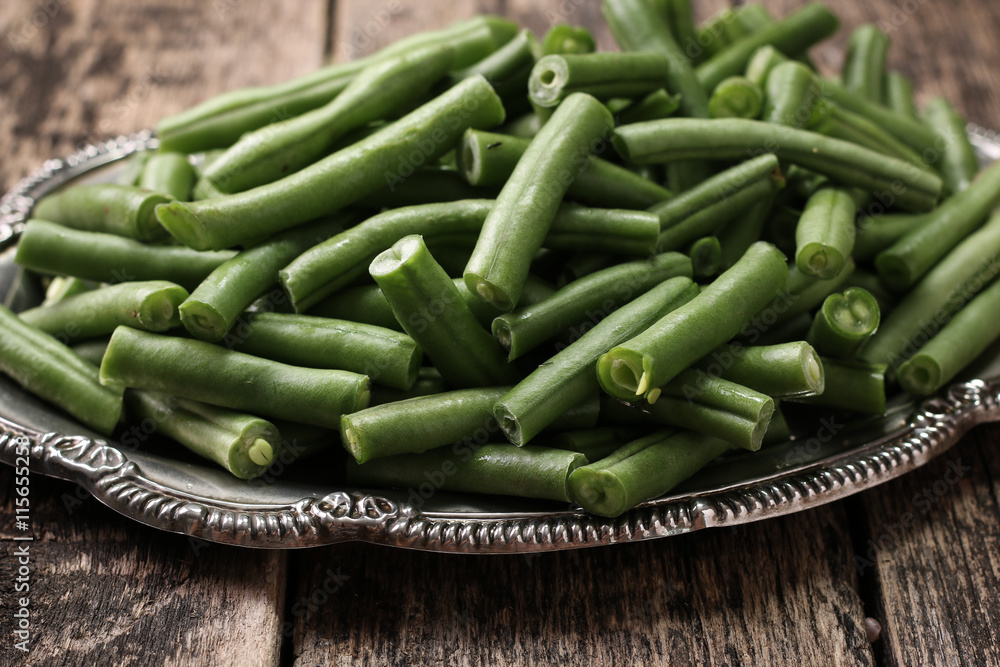 Bunch of freshly picked green beans on a wooden surface. Bunch of freshly picked green beans on a wooden surface.