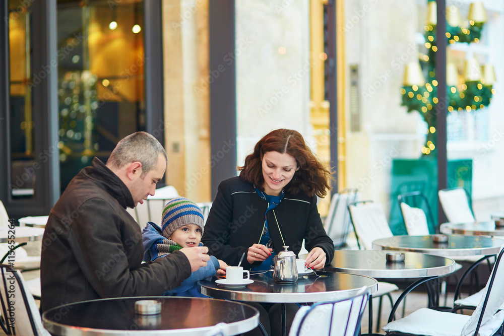 Happy family of three in outdoor cafe Happy family of three in outdoor cafe