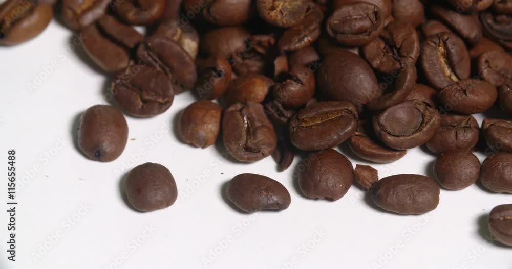 Coffee Beans Above Pile Close Up Bottom Edge on White Spins. From above lower side of a pile of brown coffee beans spins right on white
Coffee Beans Above Pile Close Up Bottom Edge on White Spins. From above lower side of a pile of brown coffee beans spins right on white