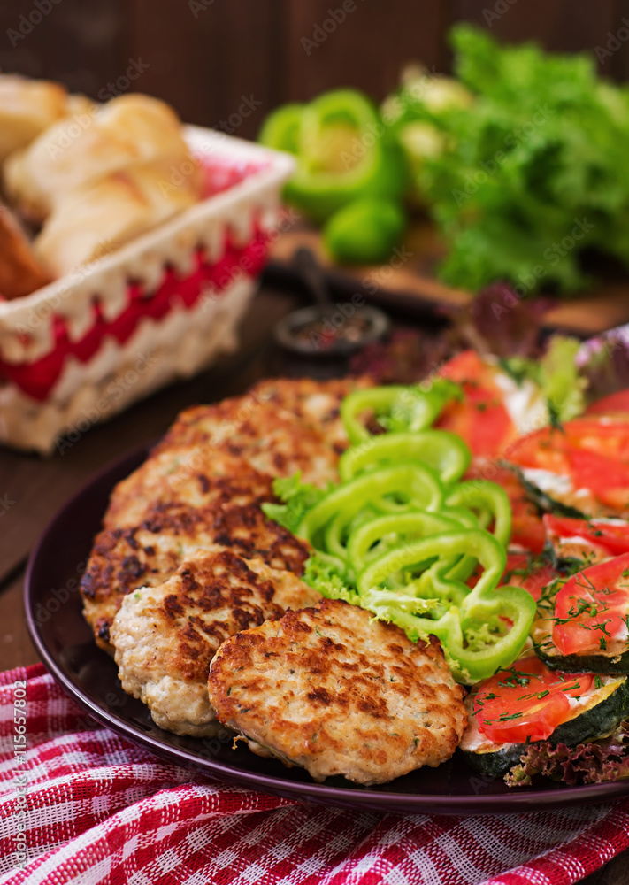Dish with a snack of fried zucchini with tomatoes and succulent chicken