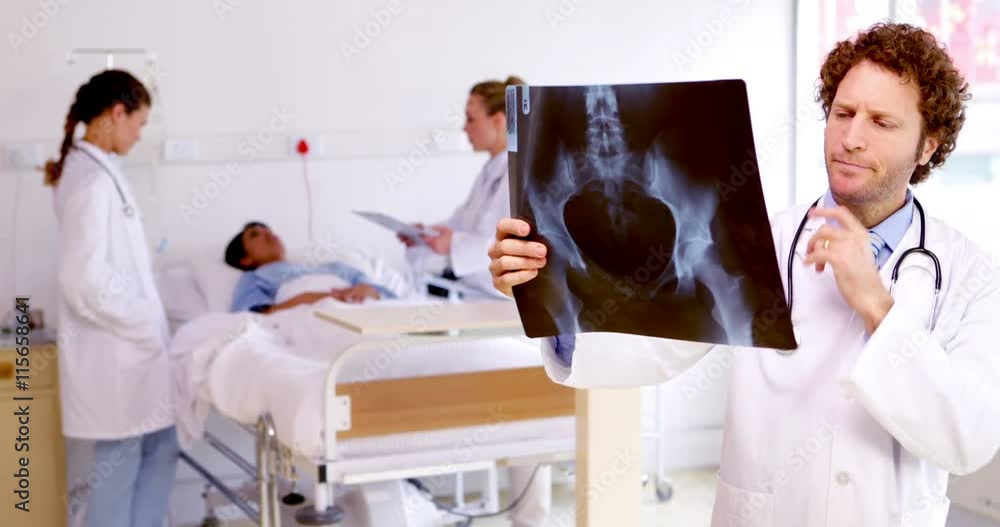 Doctor examining xray in the ward Doctor examining xray in the ward