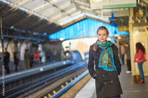 Young woman waiting for a train on the platform of Parisian unde