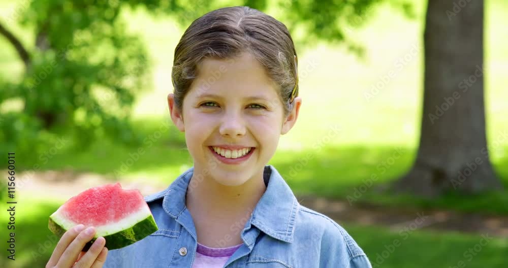 Cute little girl eating watermelon in the park Cute little girl eating watermelon in the park