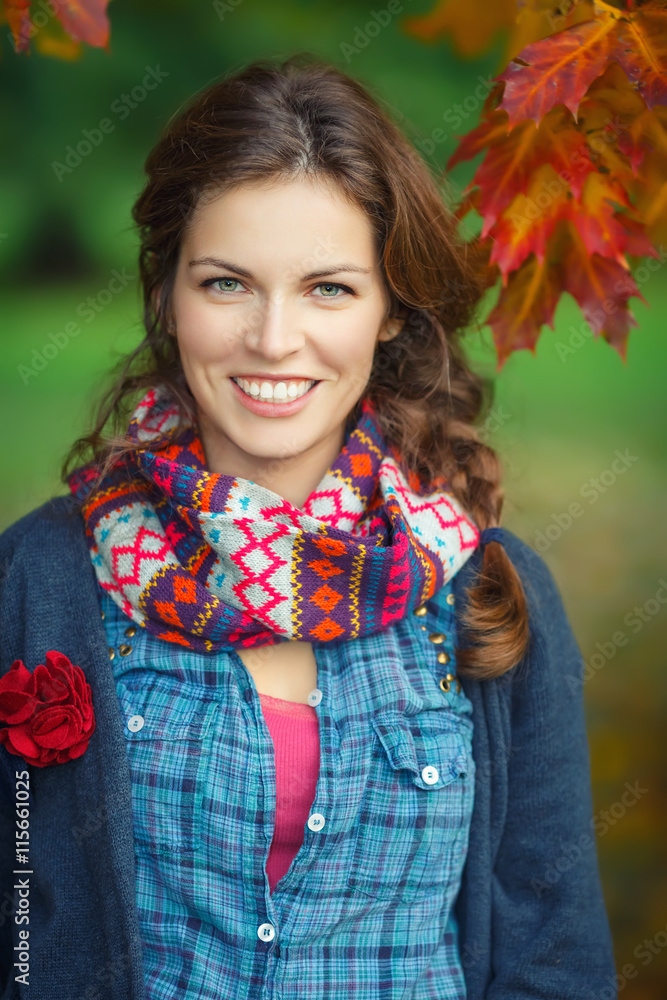 Outdoor portrait of young stylish woman in autumn park