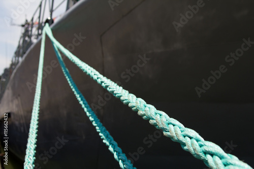 Fototapeta mooring rope holding the ship at the pier