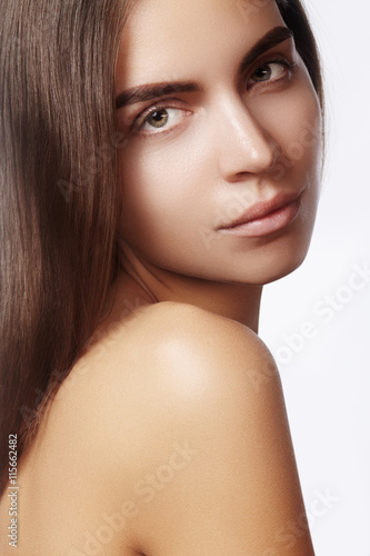 Beautiful young woman with clean skin, beautiful straight shiny hair, fashion makeup. Glamour make-up, perfect shape eyebrows. Portrait sexy brunette. Beautiful smooth hairstyle