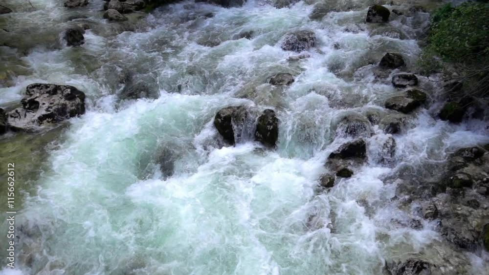 SLOW MOTION: flowing water over stones in mountines river SLOW MOTION: flowing water over stones in mountines river