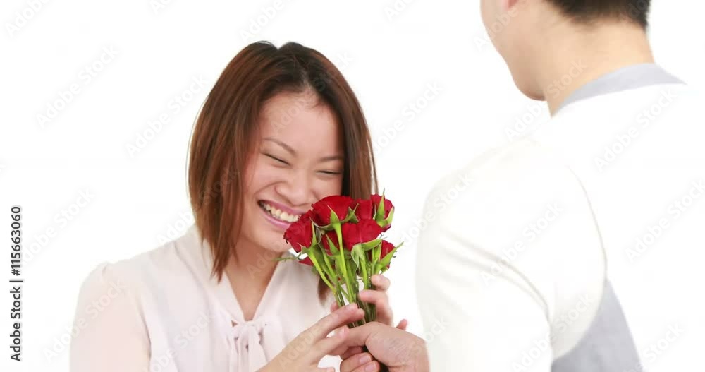 Man offering flowers to his girlfriend on white background Man offering flowers to his girlfriend on white background