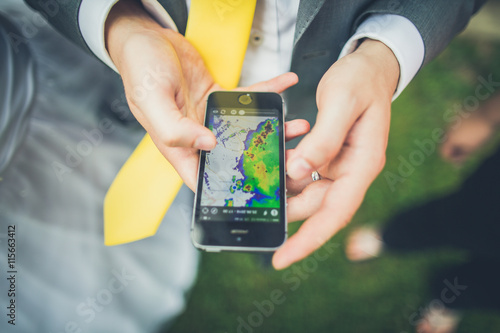Фотография Detecting the weather forecast with rain radar on mobile phone