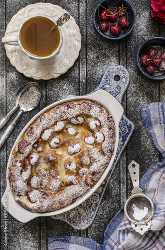 Clafoutis with cherries and powdered sugar for breakfast  