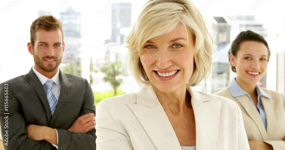 Smiling business team looking at camera