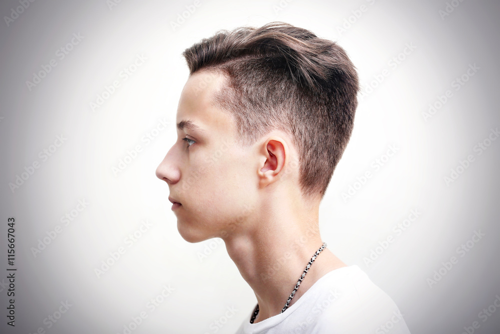 Obraz premium Young man profile face over gray background