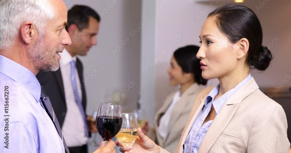 Business team chatting after work and drinking wine Business team chatting after work and drinking wine