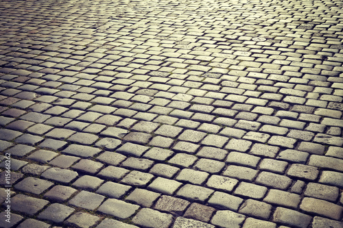 Vintage toned cobblestones at sunrise, street in Poznan, Poland.