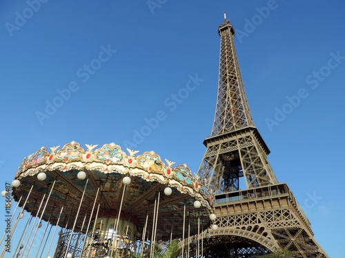 Eiffel Tower in Paris with part of the carousel showing in front, on a clear blue sky day © Regis L. Sebastiani