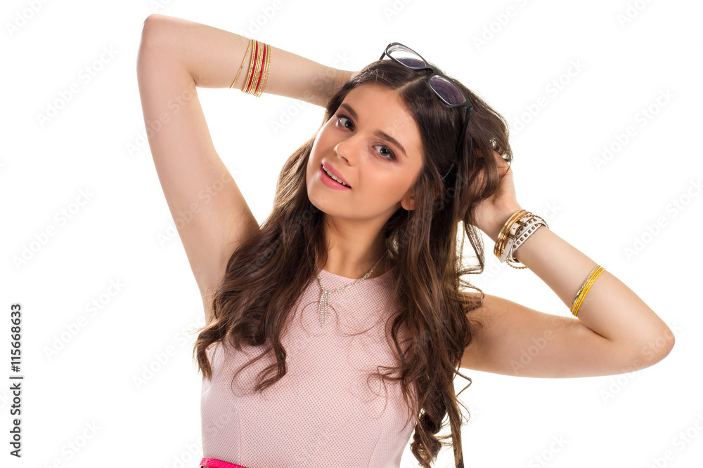 Woman touches hair. Girl with necklace and bracelets. Cute model in sleeveless dress. Slightly attractive gesture. Woman touches hair. Girl with necklace and bracelets. Cute model in sleeveless dress. Slightly attractive gesture.