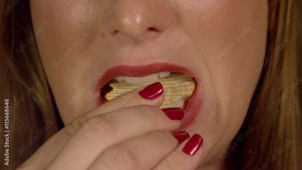 SLOW MOTION CLOSE UP: Woman eating chips SLOW MOTION CLOSE UP: Woman eating chips