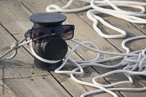 Mooring rope on the pier and sunglasses. Life style © DmyTo